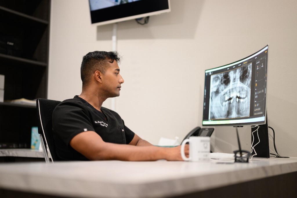 Dr. Anish Reddy reviewing panoramic x-rays at Reddy Dental