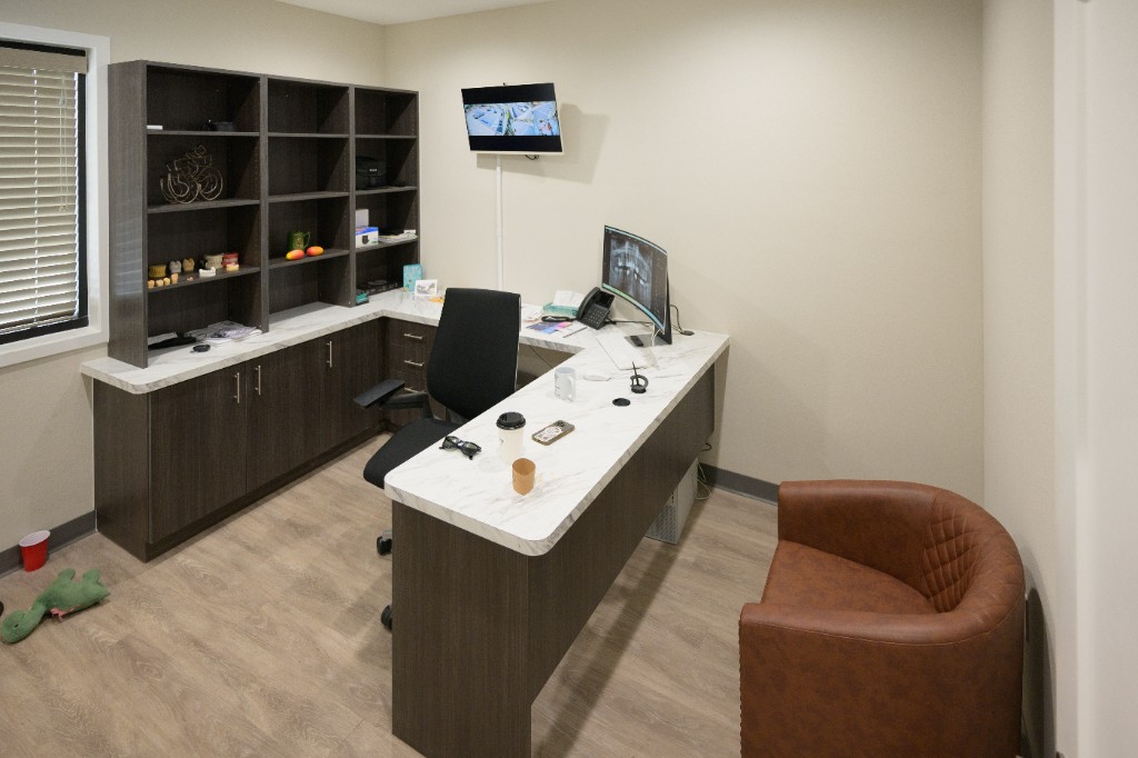Consultation office with panoramic x-ray display at Reddy Dental