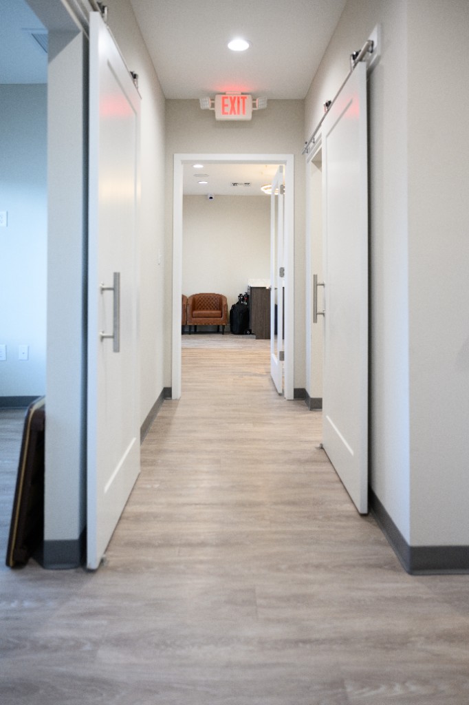 Hallway at Reddy Dental with sliding doors and waiting area
