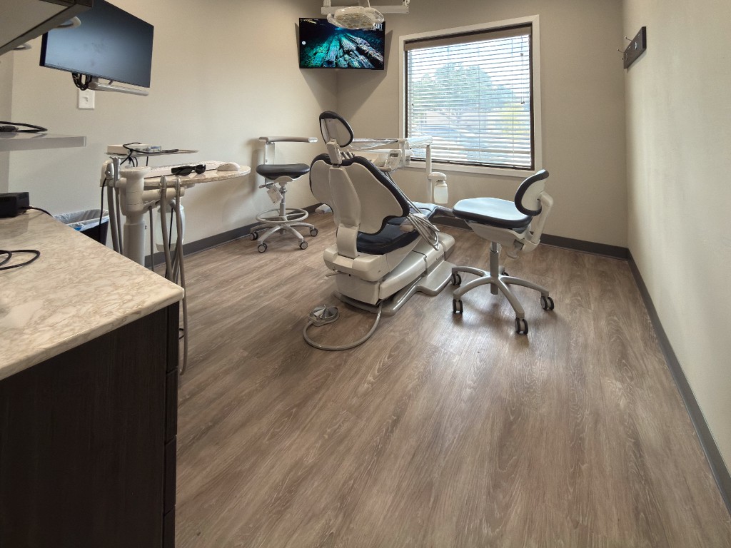 Dental operatory with patient chair and monitor at Reddy Dental